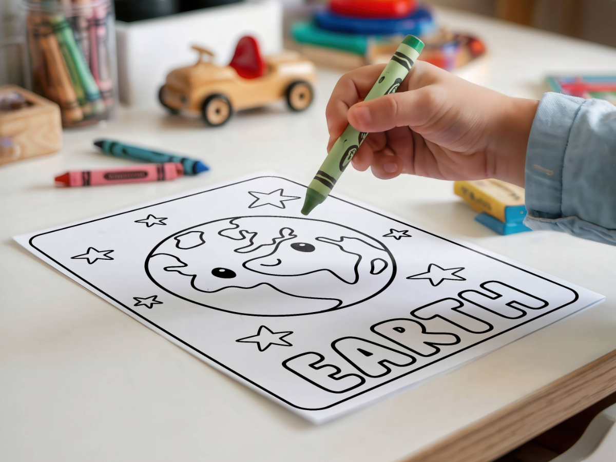 A child colours an Earth colouring page at a desk.