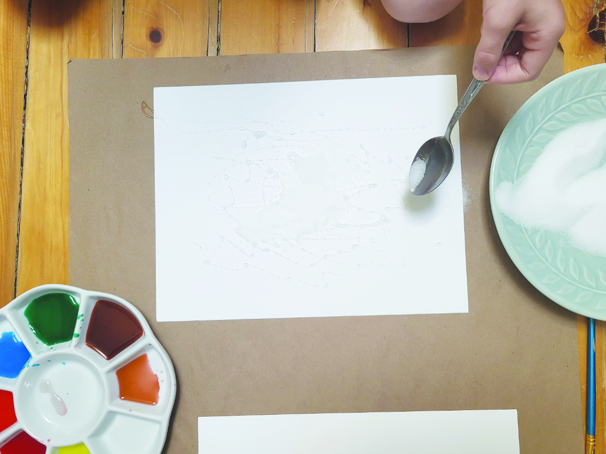 Adding salt on top of glue to make an abstract salt art picture. 