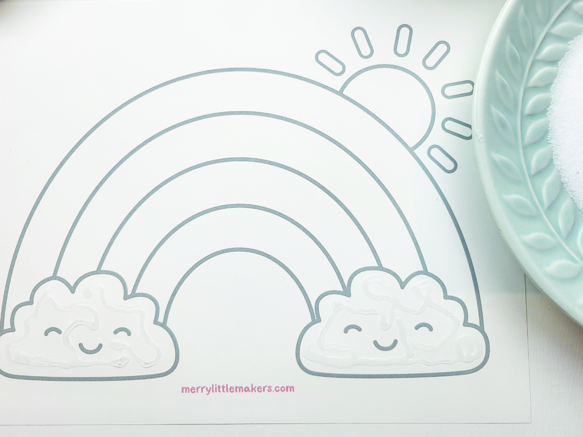 Rainbow template with glue on the cloud shapes. 