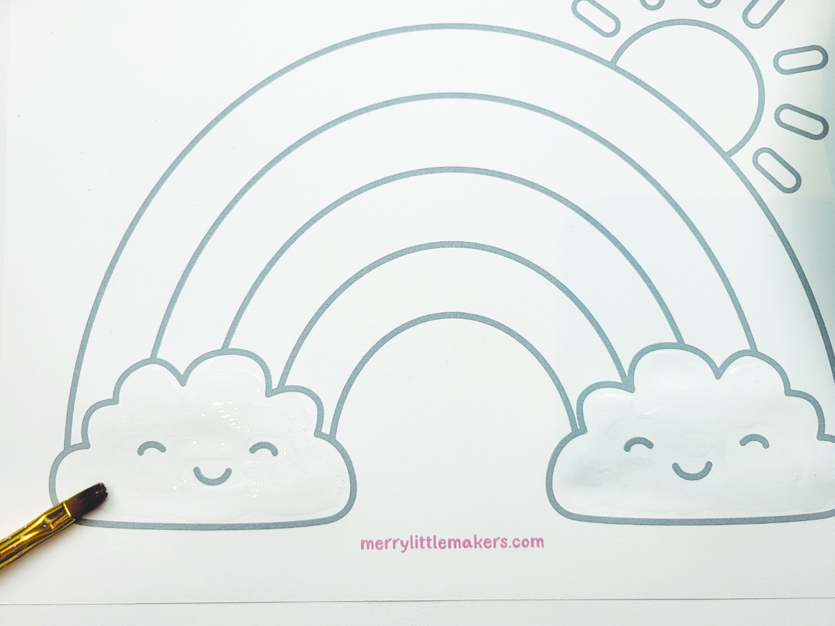 Spreading the glue on the clouds with a paint brush. 