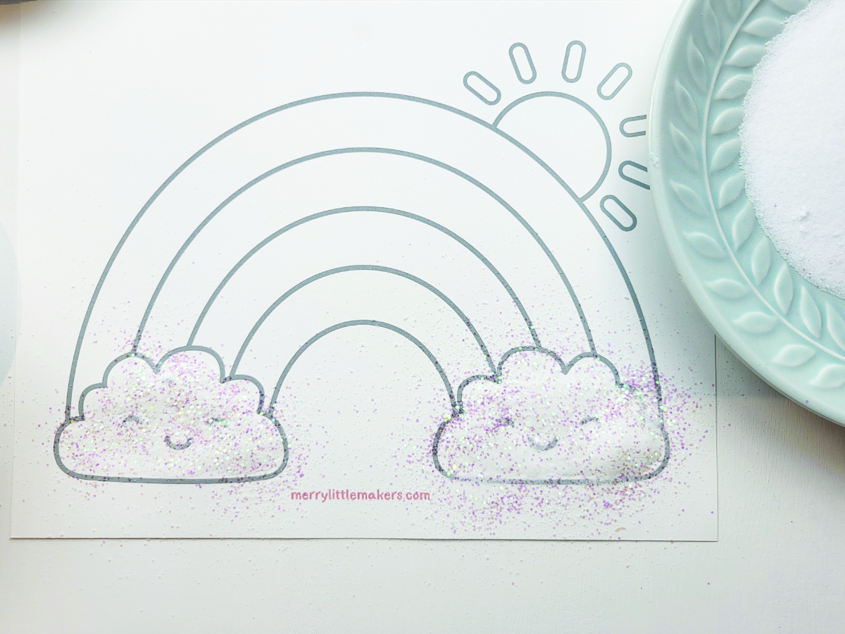 Sprinkling glitter/salt mix onto cloud shapes. 