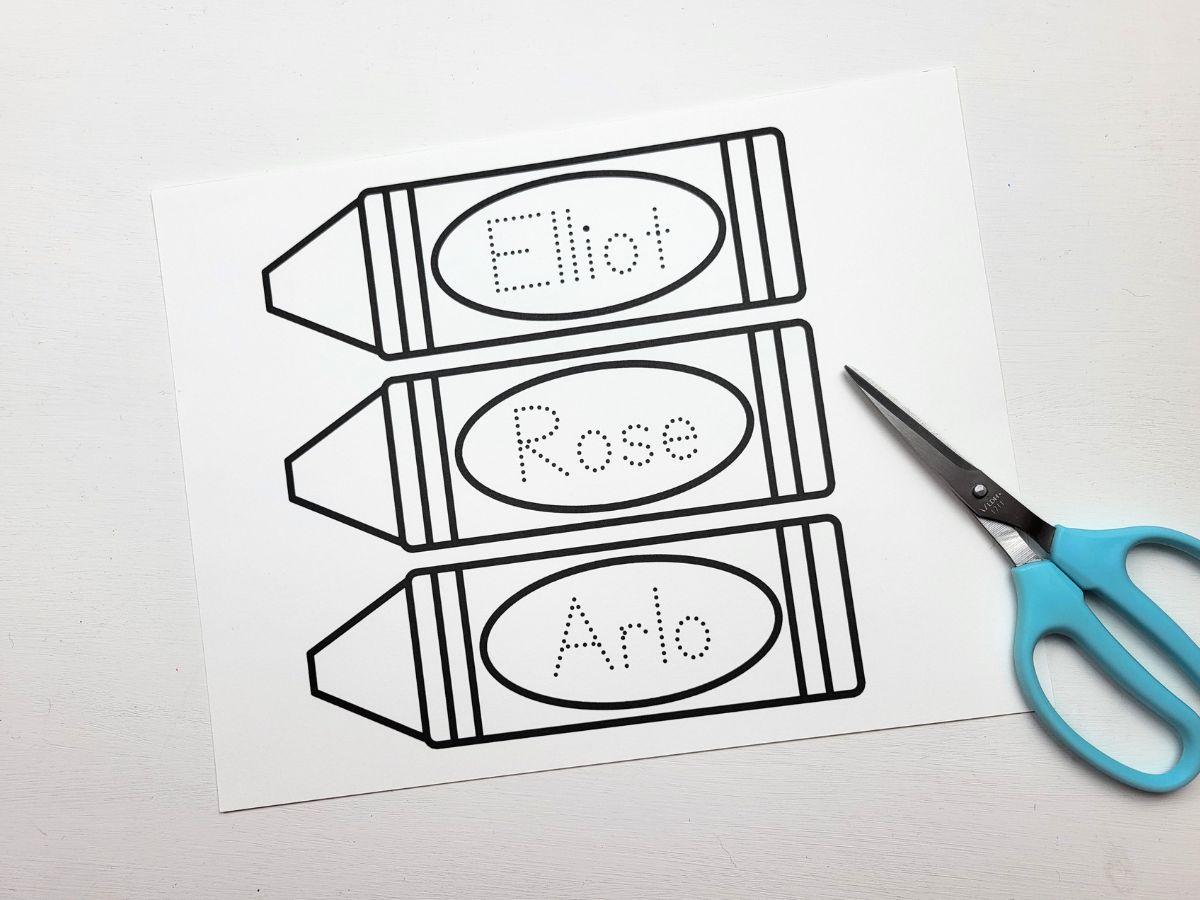 The Crayon Bookmark template   with a pair of scissors beside ready to be cut out.