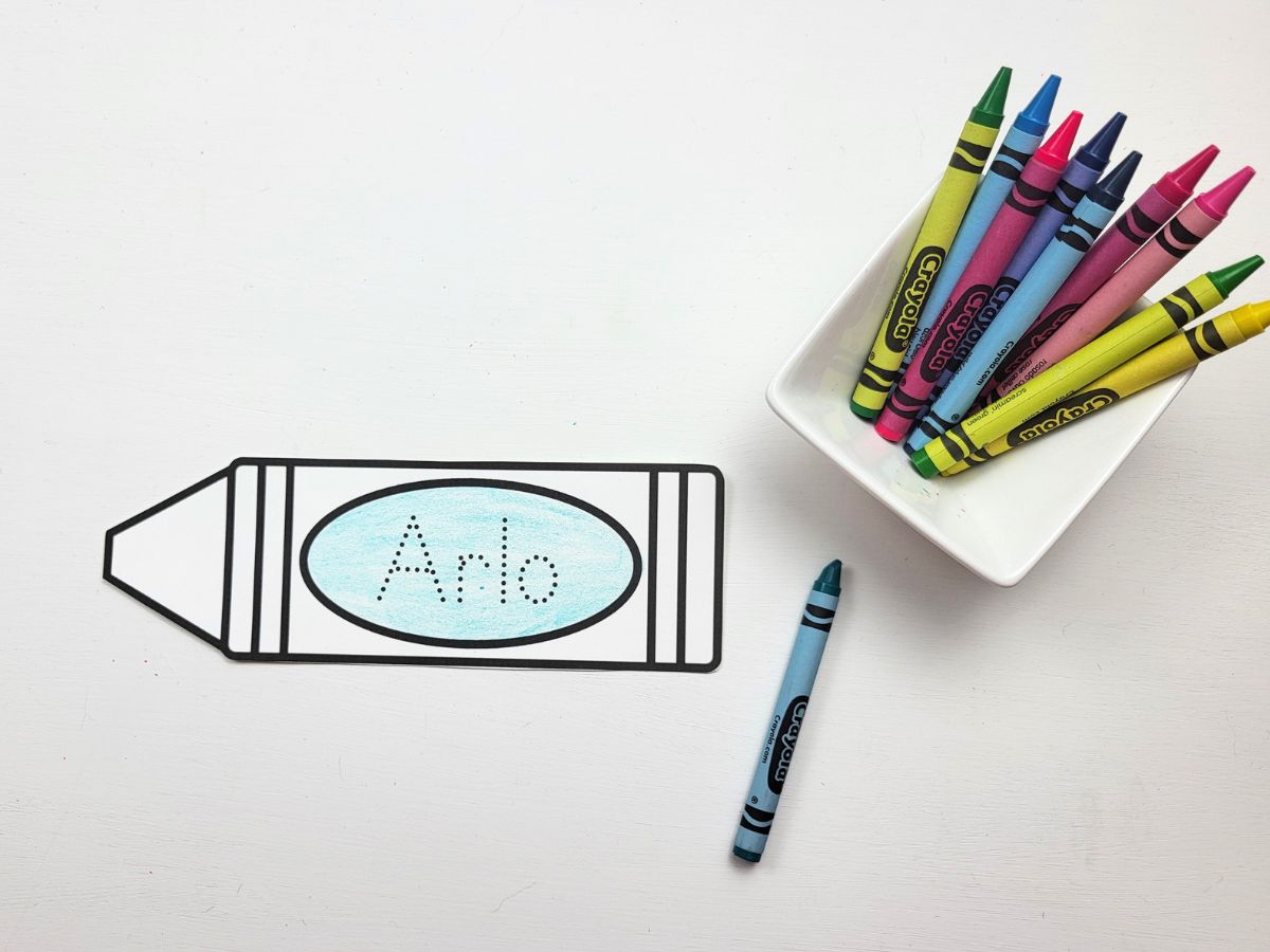 A partially colored crayon name bookmark.